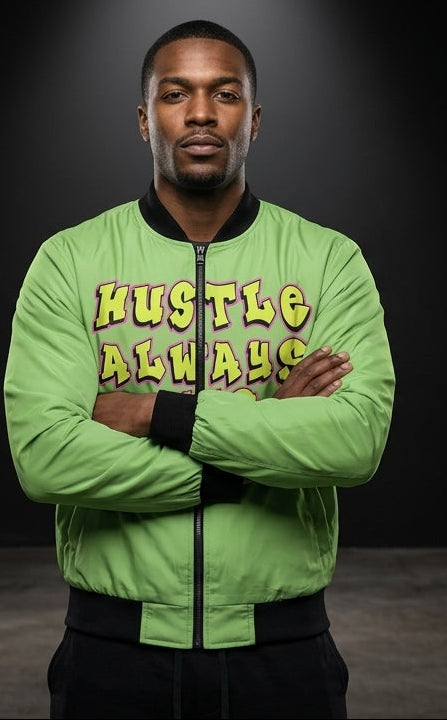 A man modeling a bright green bomber jacket in a studio setting, shown from both the front and back. The front features the text 'HUSTLE ALWAYS' in yellow, and the back displays a large cartoon illustration of a man wearing a green cap and yellow jacket.